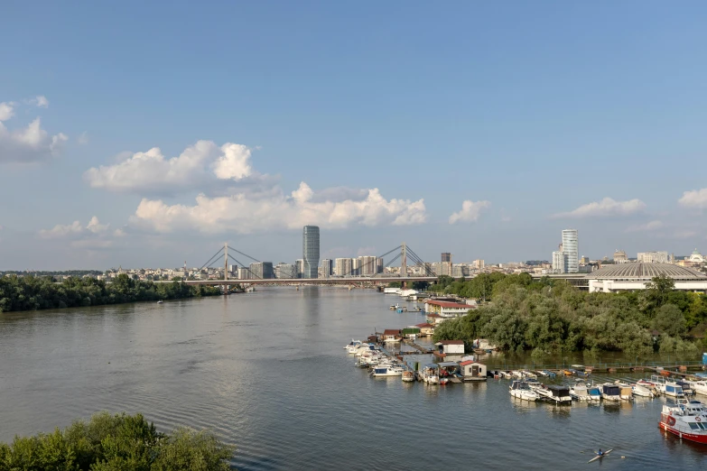 a body of water with boats in it next to buildings and tall buildings