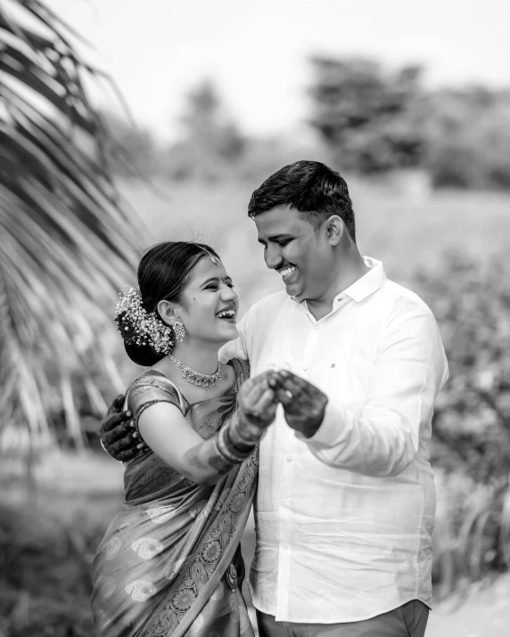 a smiling man and woman are holding each other