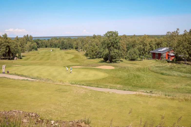 a large grassy golf course on a nice day