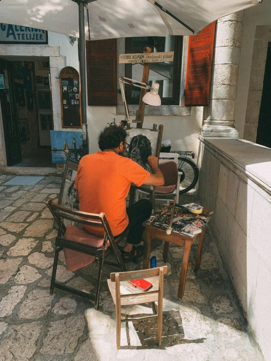 a man sitting at a desk working on his computer