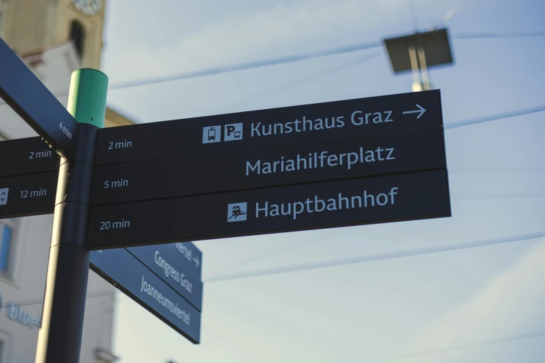 a city intersection with various road signs showing the direction