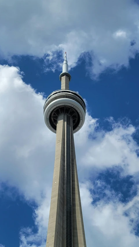 a very tall tower under a cloudy blue sky