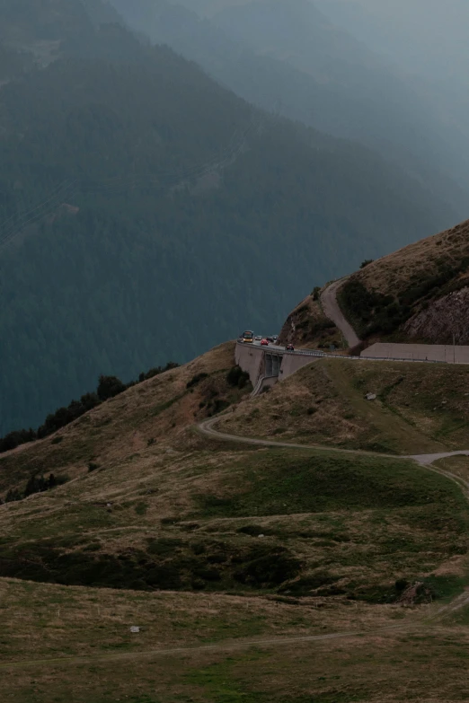 people walking up the road in the mountains