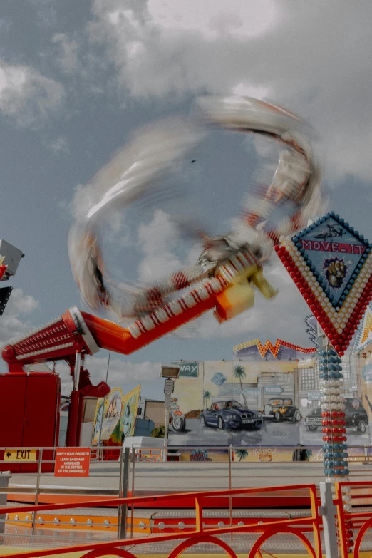 a ferris wheel riding next to the carnival ride