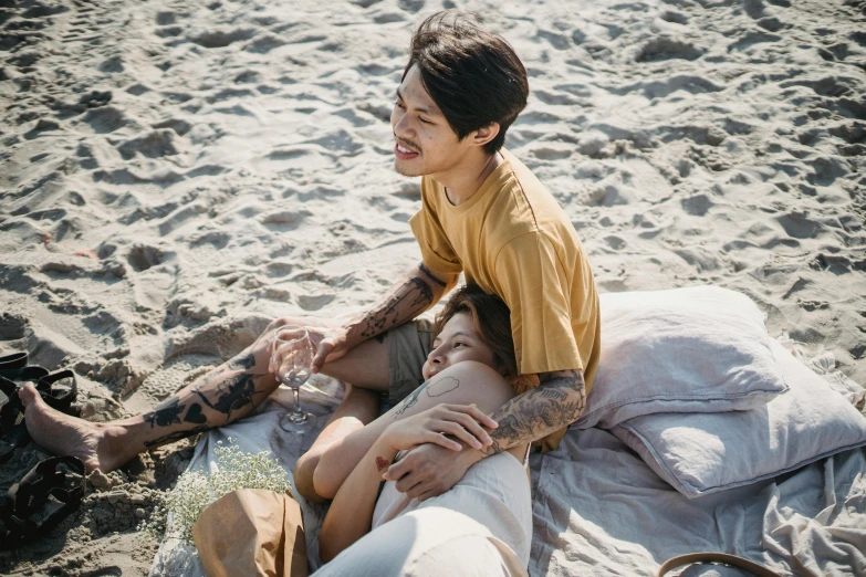 a couple sitting together on the sand