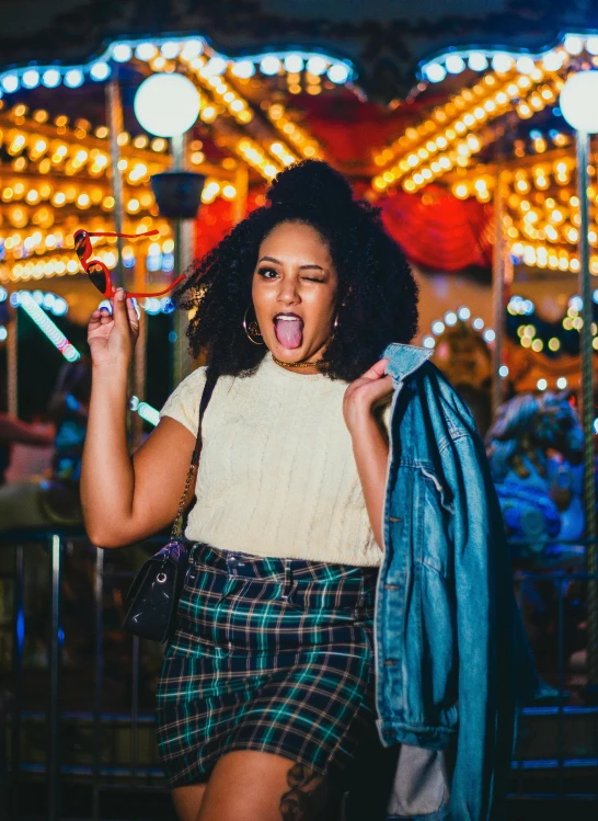 a young woman wearing plaid skirt and jacket with an umbrella