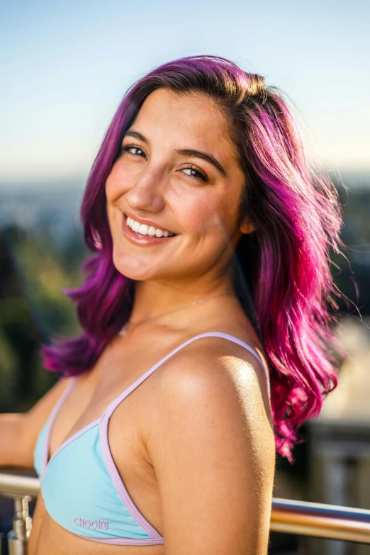 a pretty young lady wearing a pink and blue bikini