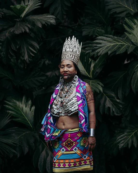 an african woman in colorful clothing poses for the camera