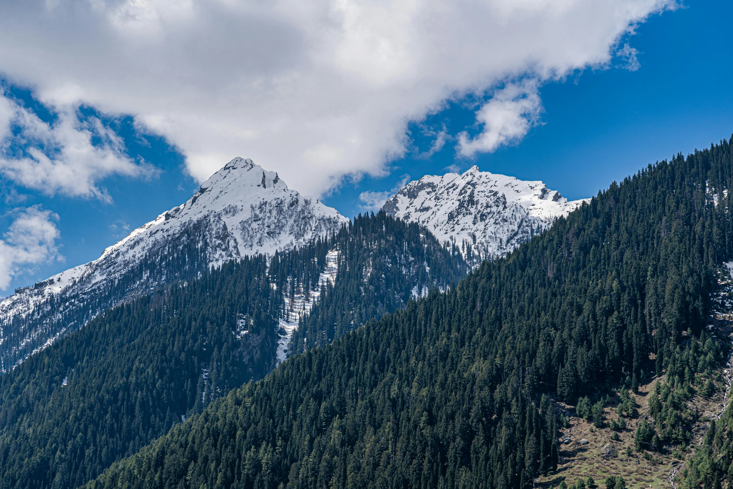 a view of some mountain side with a very big mountain