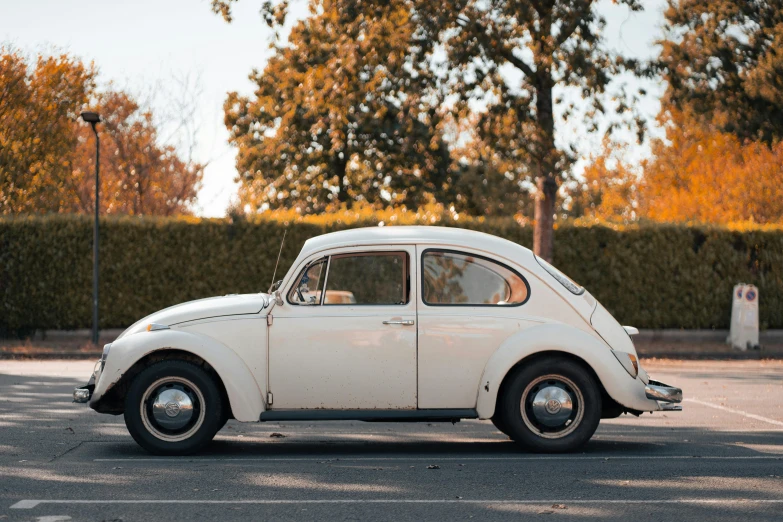 the vintage beetle is parked in the parking lot