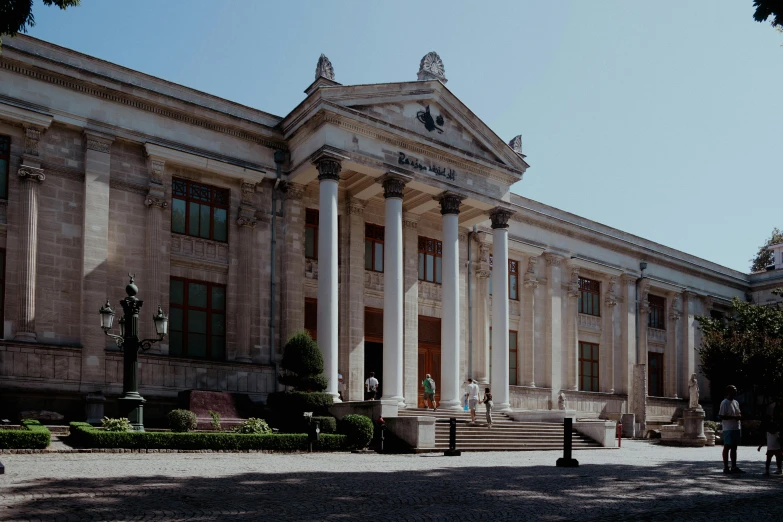 a group of people standing outside a large building