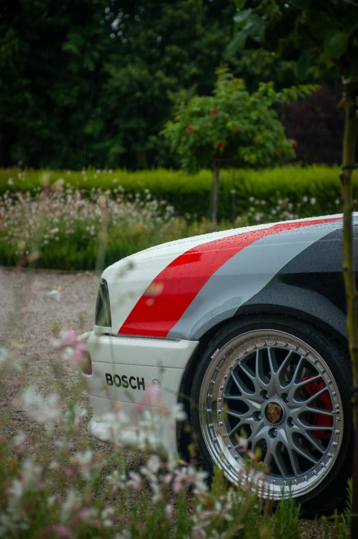 a close - up of the car's paint, tire and stripe on its fender