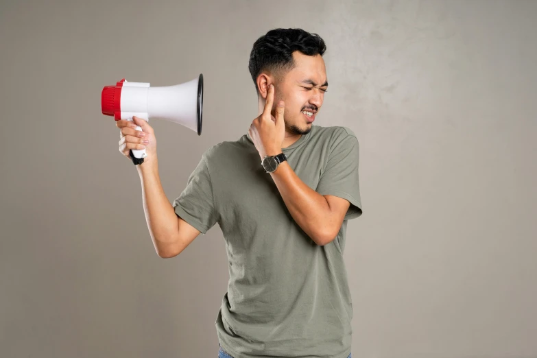 a man holding a bullhorn on a cellphone