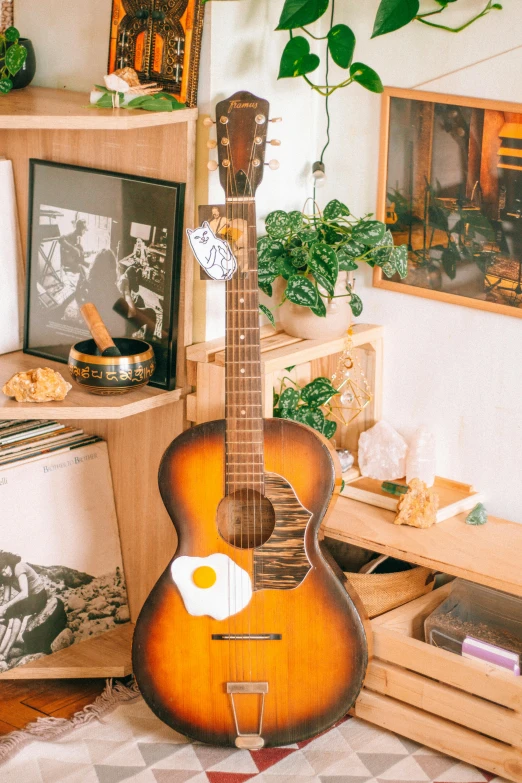 a close up of an electric guitar with a plant on it