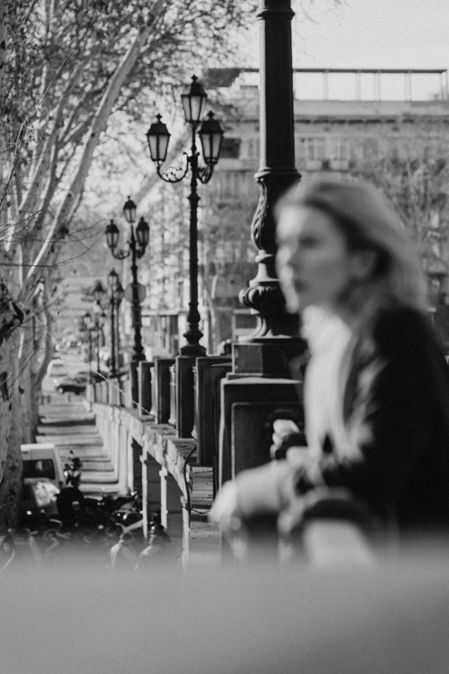 black and white pograph of a woman sitting on a park bench