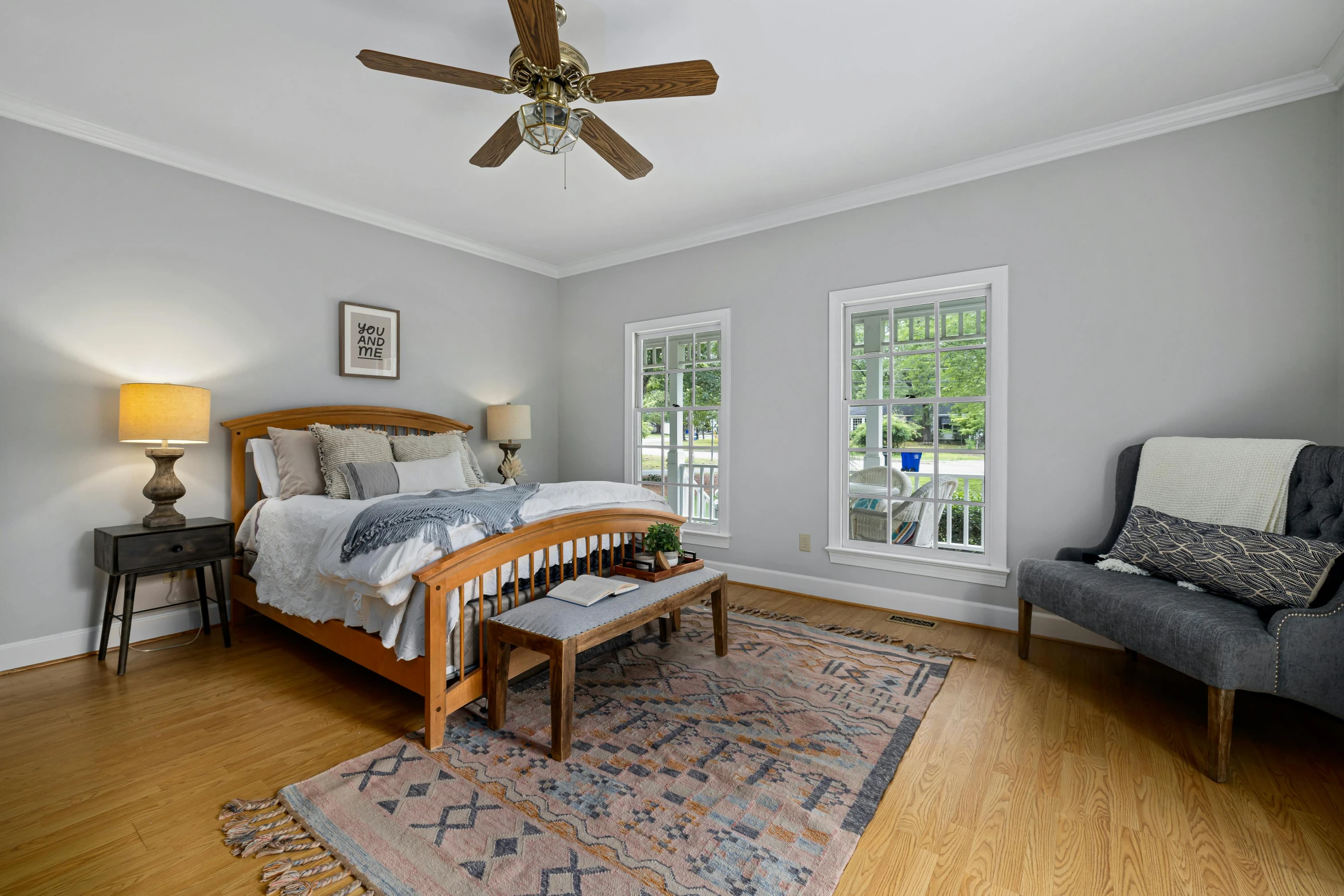 a large wooden bed sitting in a bedroom next to a couch