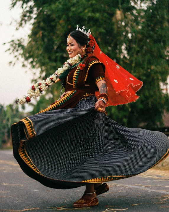 a woman wearing a blue skirt and holding a flower in her left hand