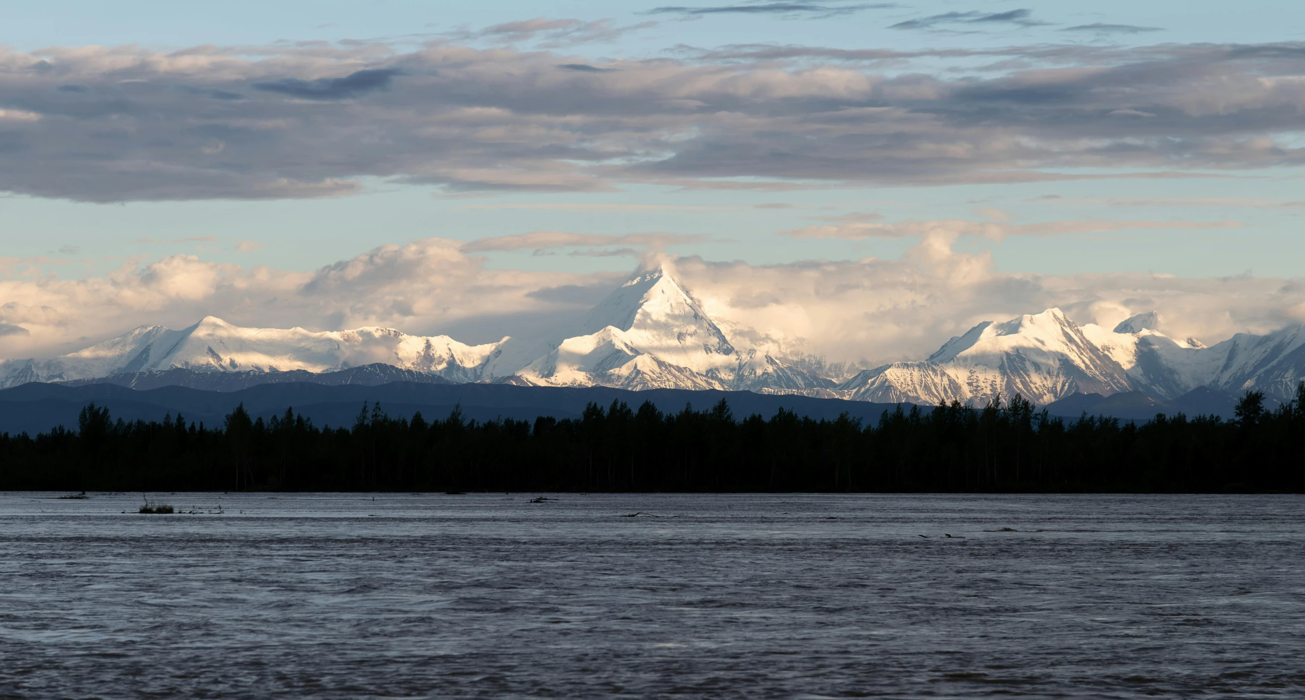 a view of the snow capped mountains in the background