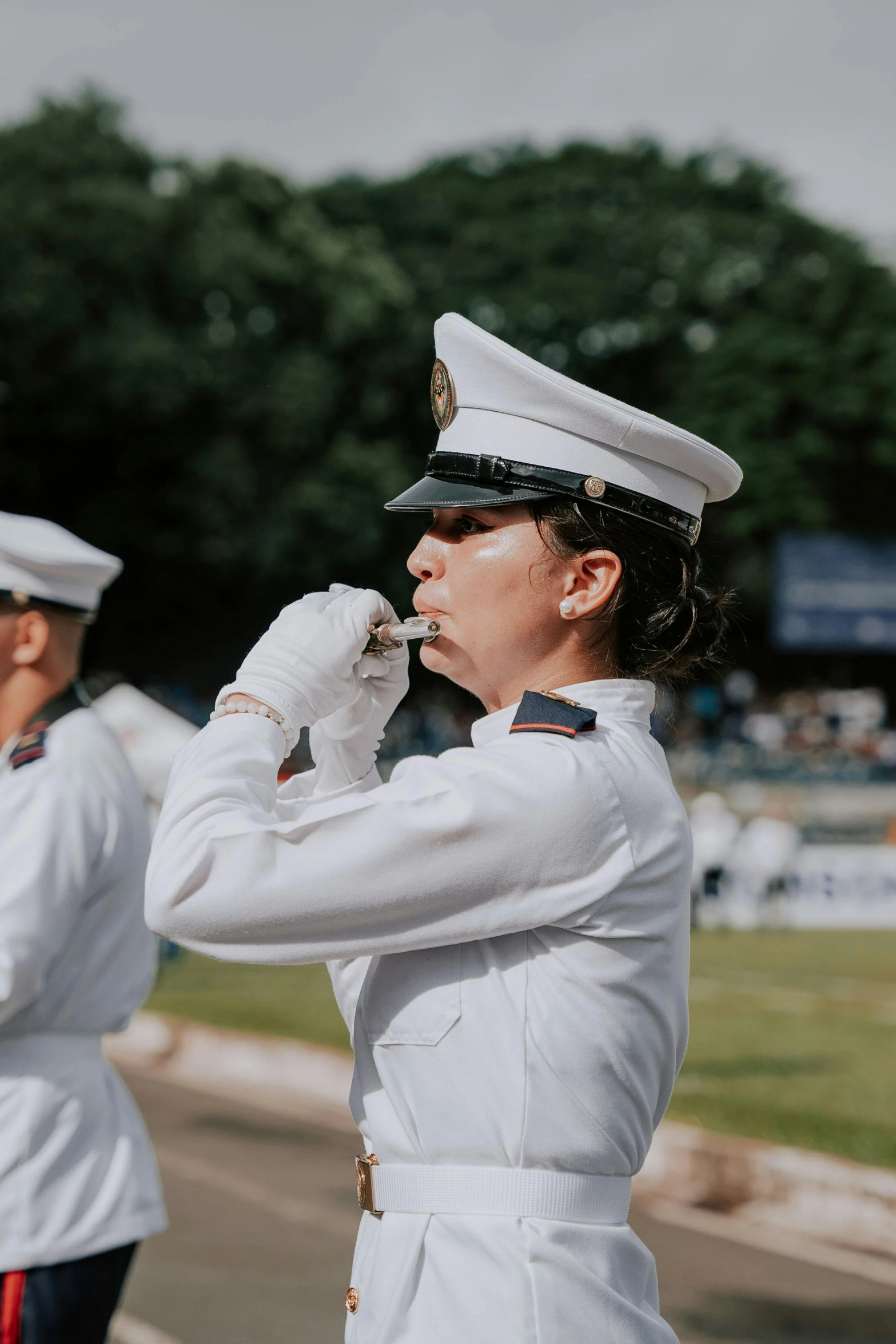 two women in uniform saluting each other