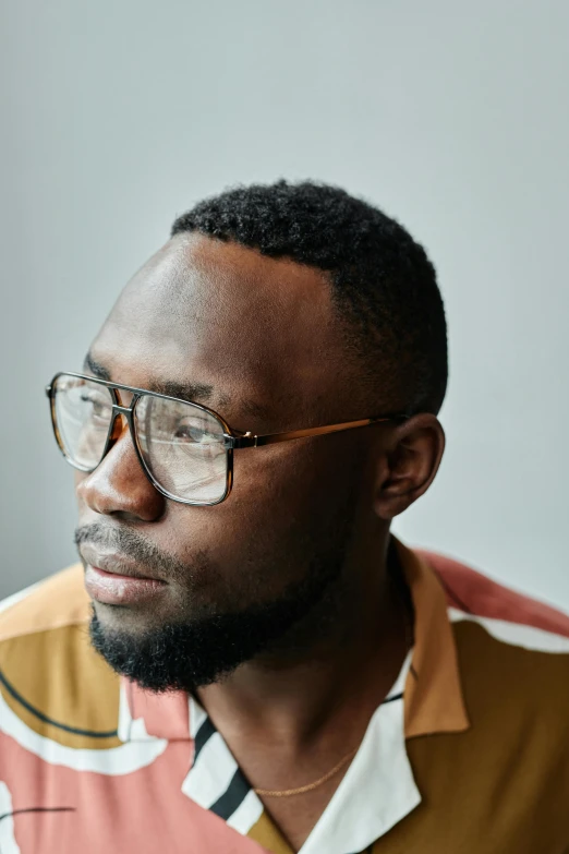 a black man is wearing glasses with a short beard