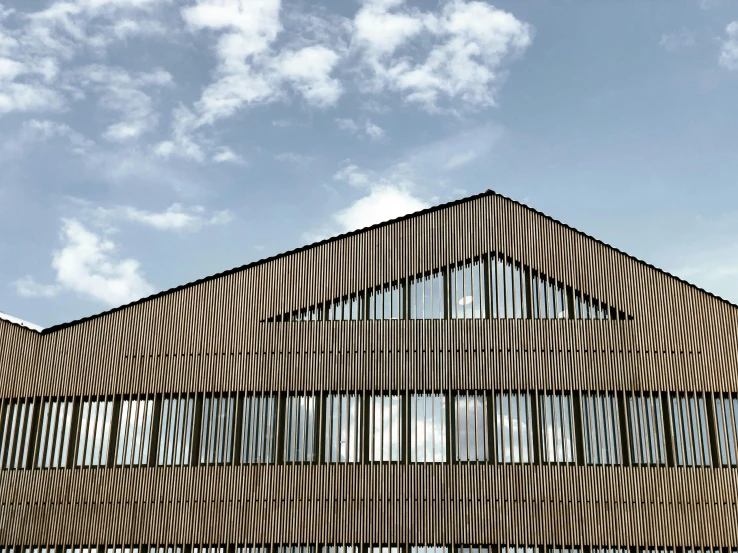 a house in front of a cloudy sky