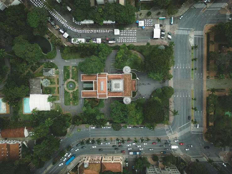 an aerial view of a city street with a clock on the corner