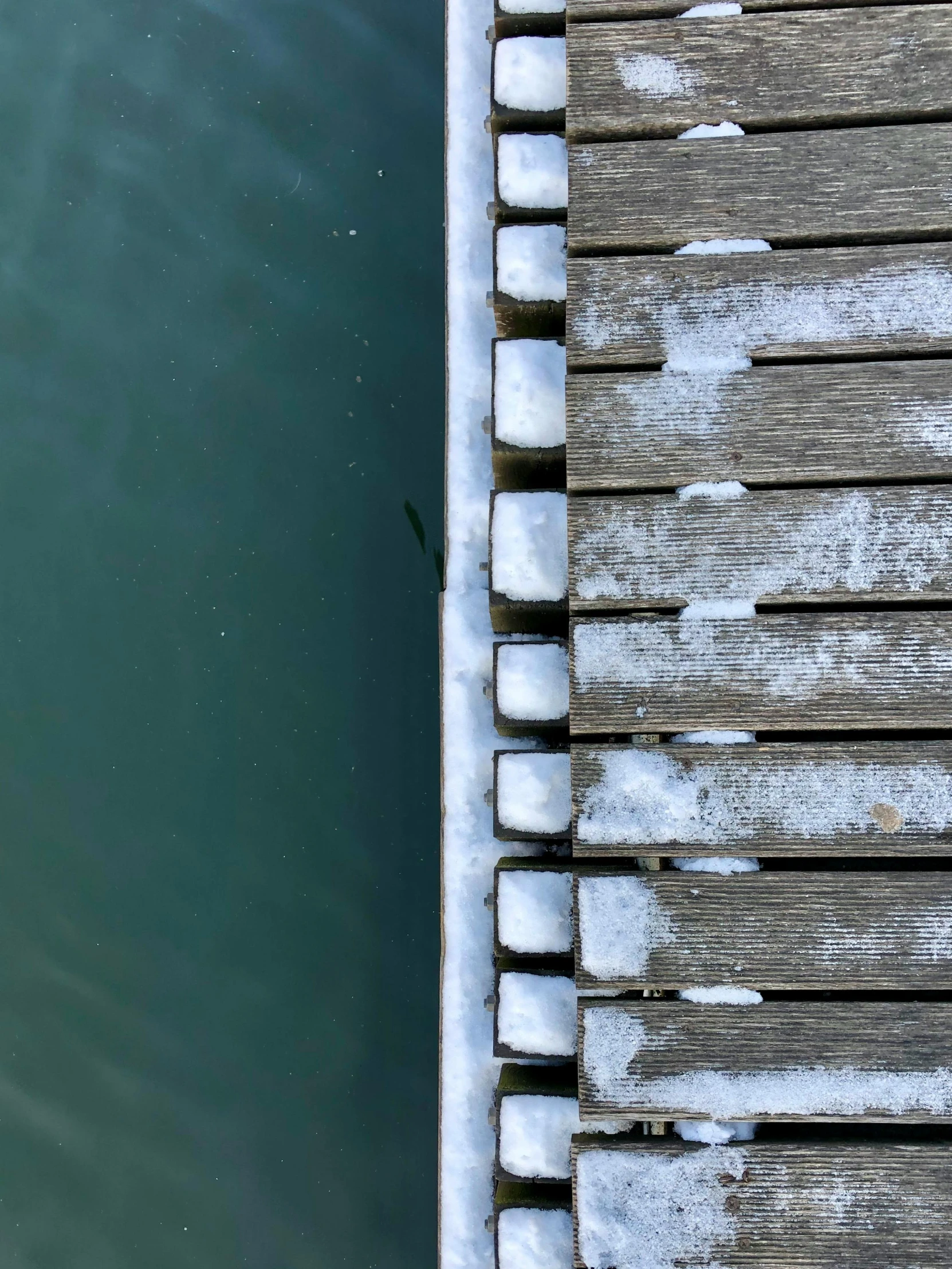 a man is standing on a dock near water