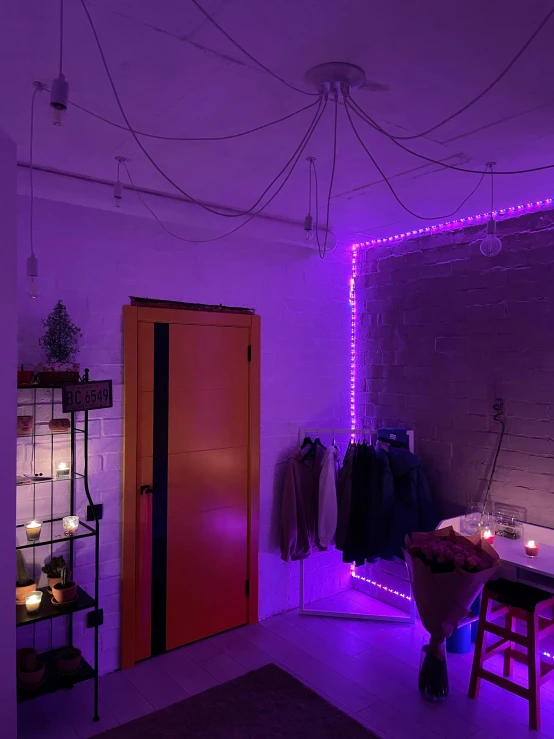 room with purple lights and a white brick wall