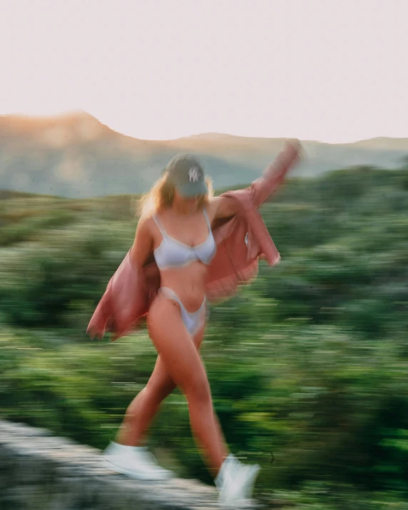 a woman in a white bikini with an umbrella