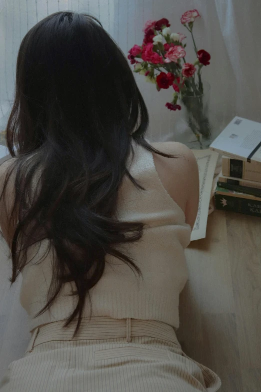 a woman sitting on a couch looking at books