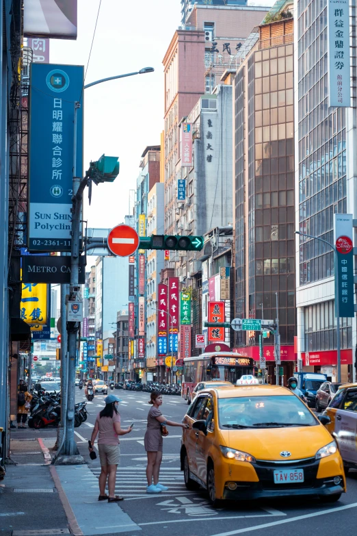 traffic and pedestrians crossing a busy asian street