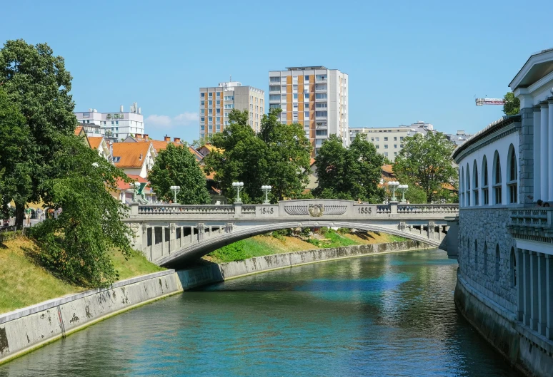 a very long bridge over a river in a city