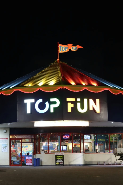 a large circus on a dark night with the top fun lit up