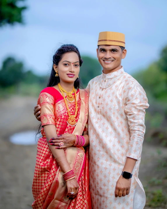 two people in traditional indian dress posing for a po