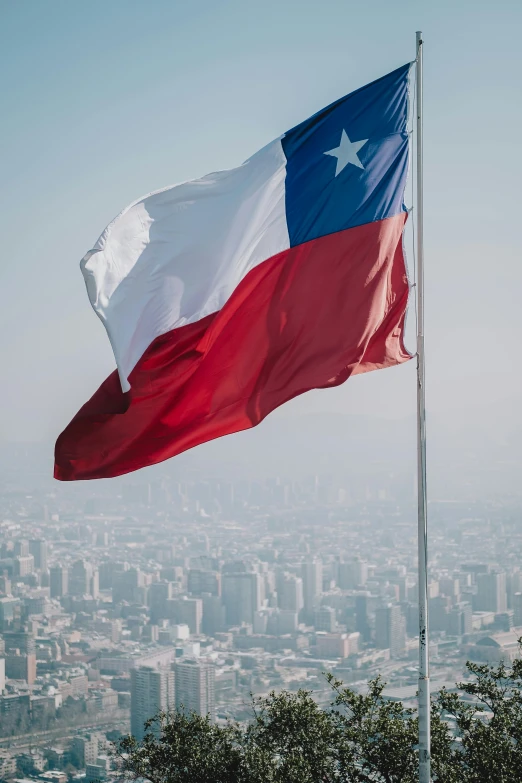 a red white and blue texas flag flying in the sky