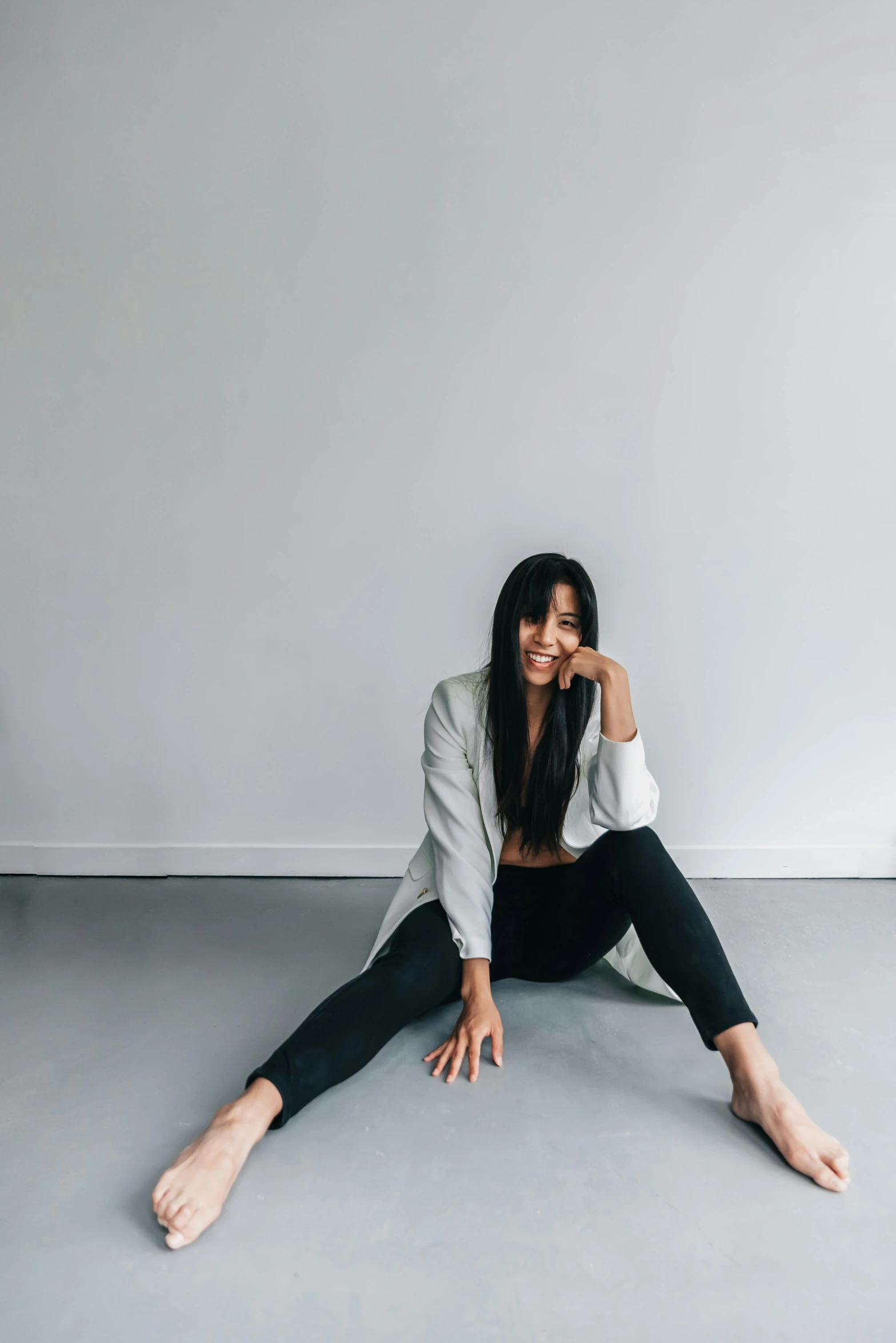 a woman sitting on the floor with her feet up