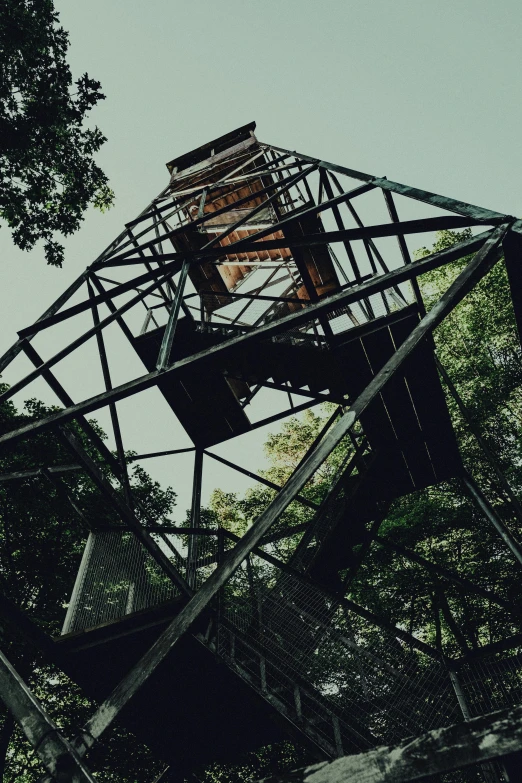 an old metal tower in the forest is broken