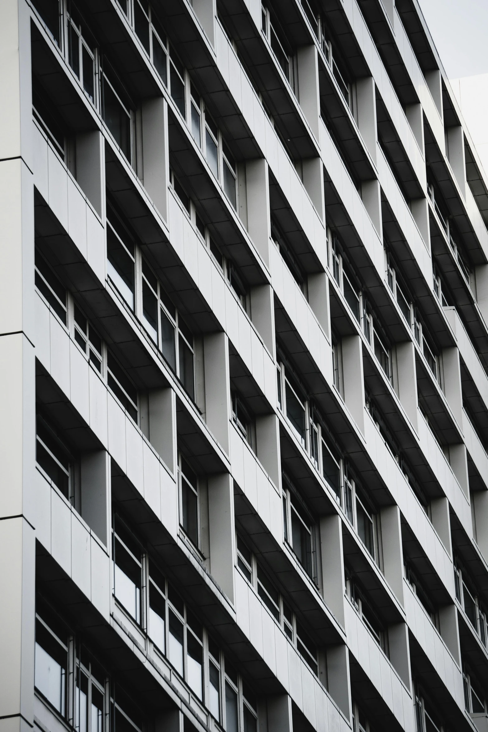 the apartment building has many balconies and windows