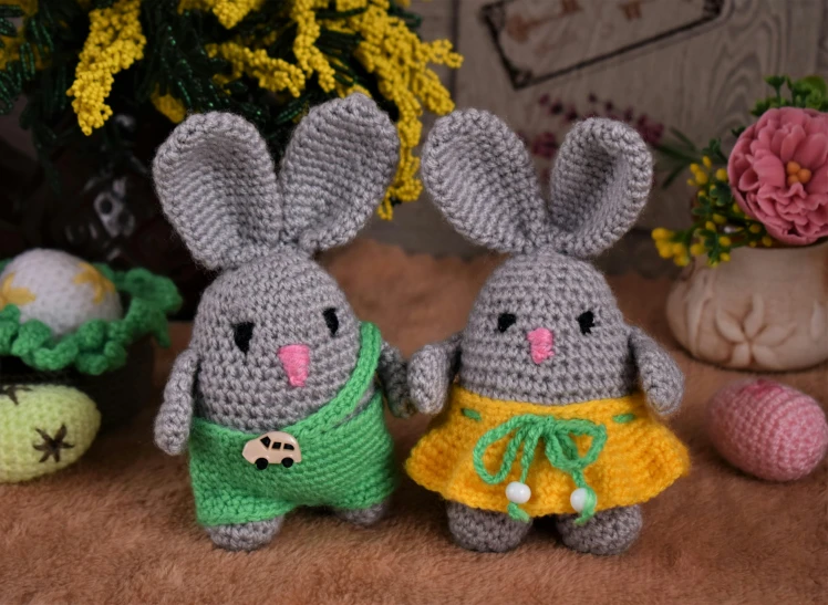 two crocheted animals standing next to each other