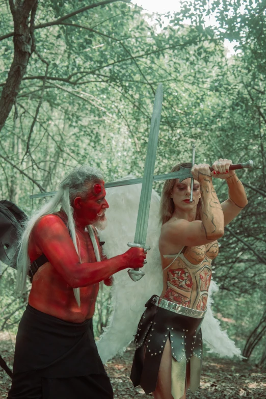 a man with a sword and woman in red makeup standing outside