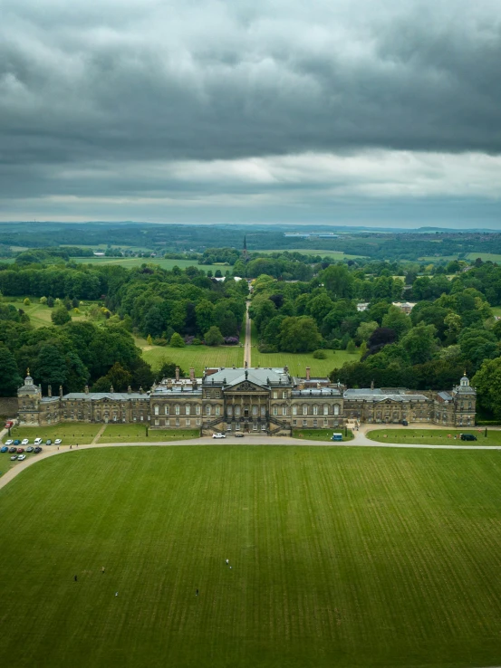 a green grassy field with an ornate building on the other side