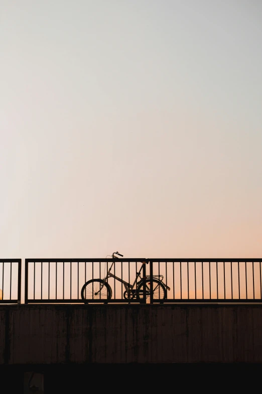 the view from a bridge shows a bicycle parked