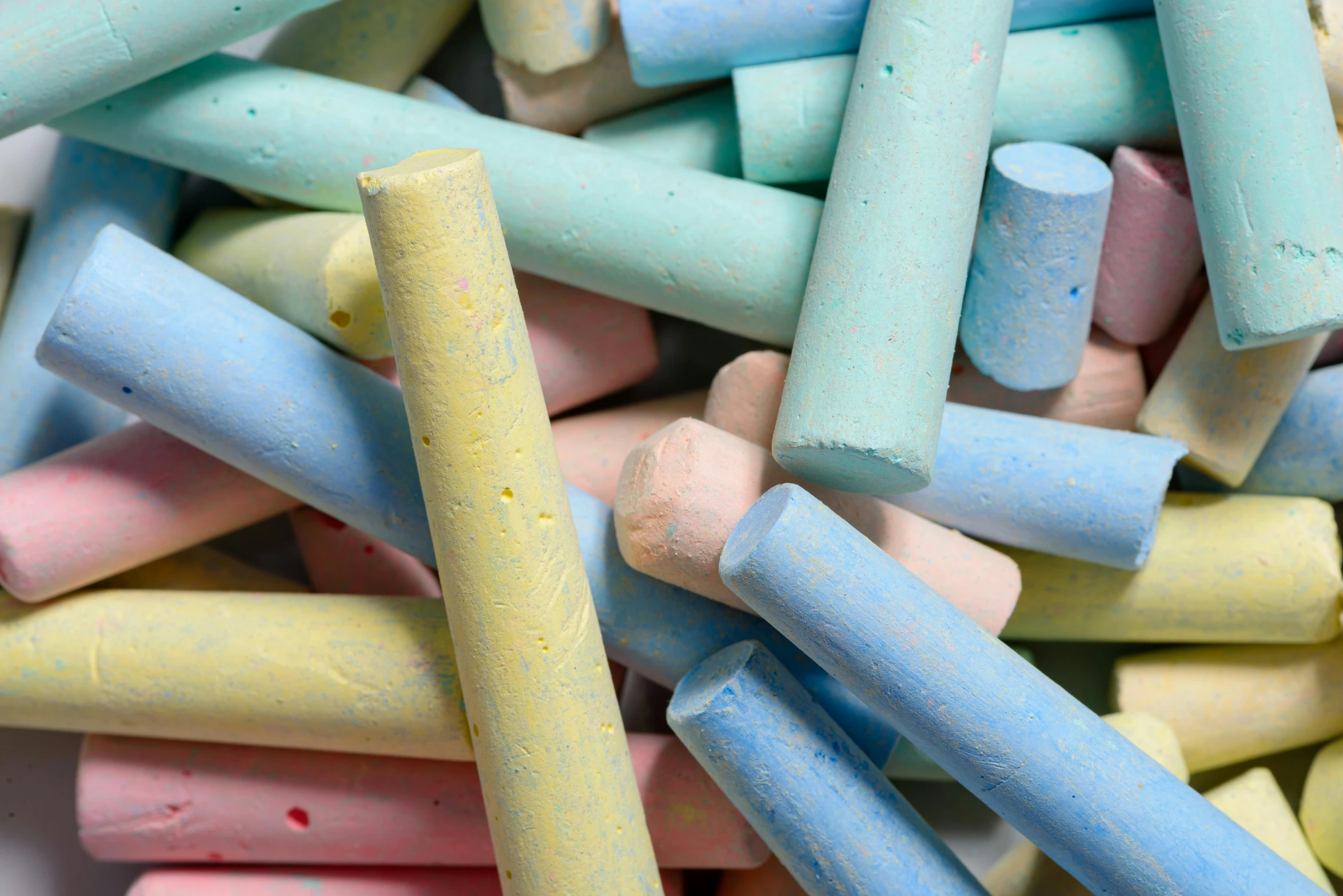 many colored crayons arranged in a pile