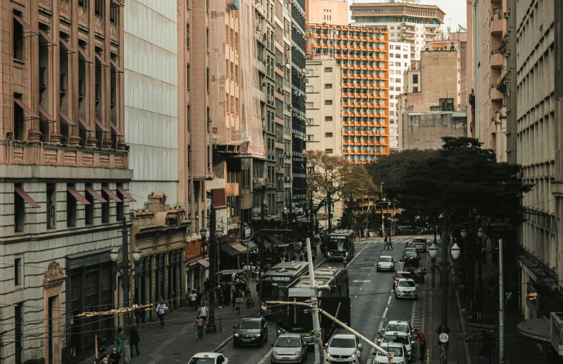 a busy city street with pedestrians, cars and bicycles