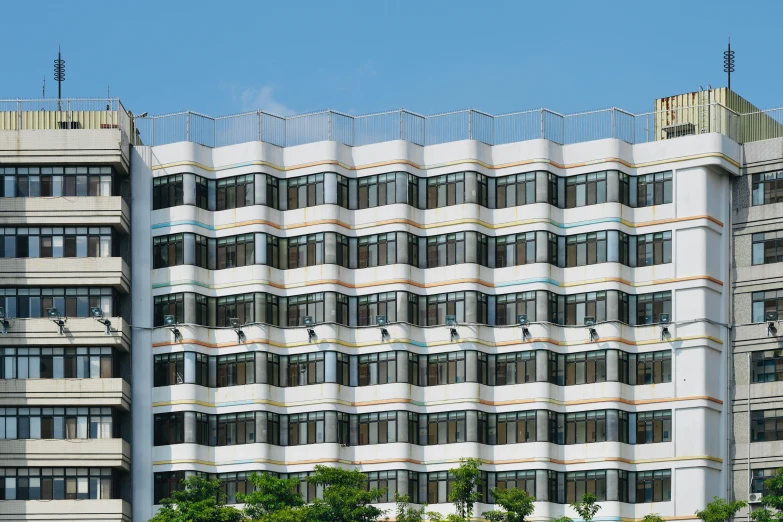 the building is white and grey and has windows