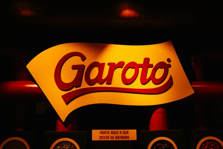 a logo for a restaurant on display on a dark wall