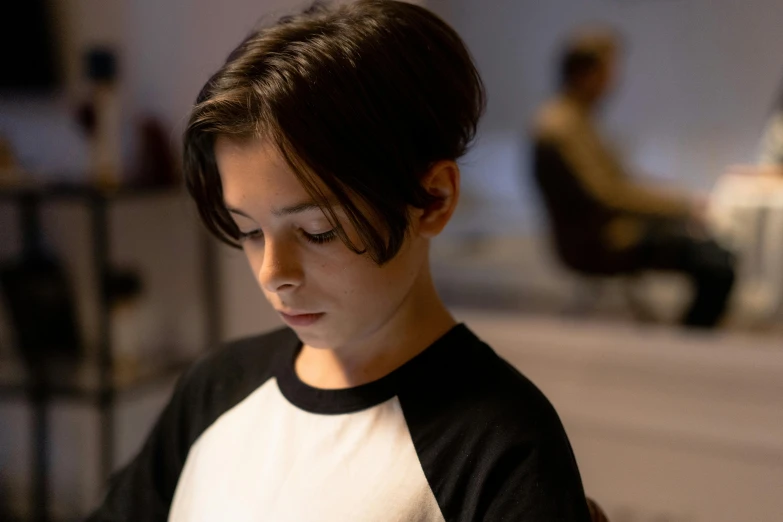 a girl texting on her cell phone, in a darkened room