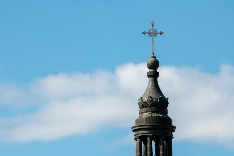 a church steeple with a cross on top