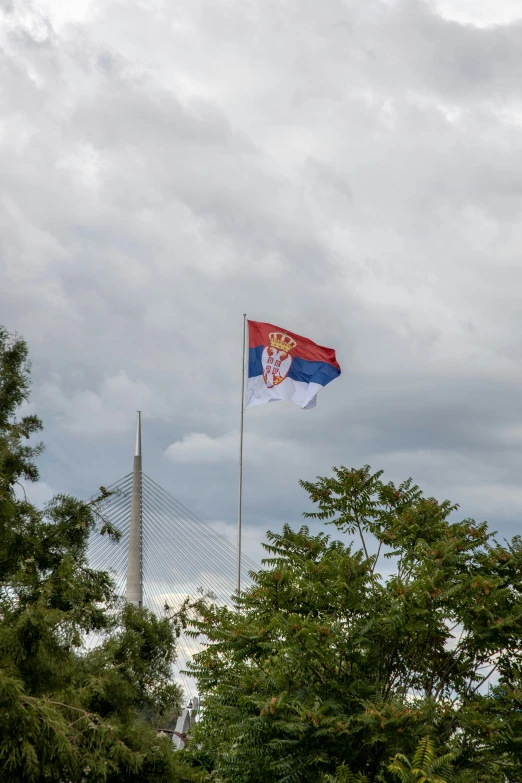 there is a flag on the pole above a field