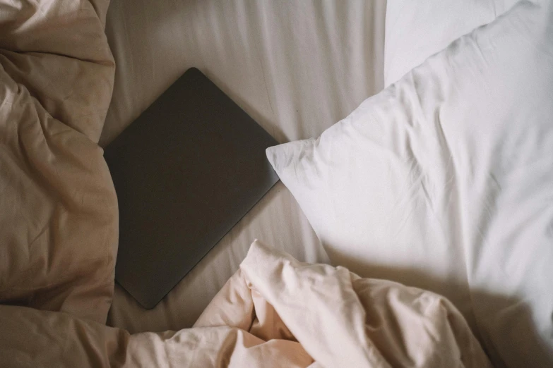 an open laptop computer on a bed